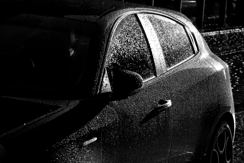 a car door with raindrops on the windshield