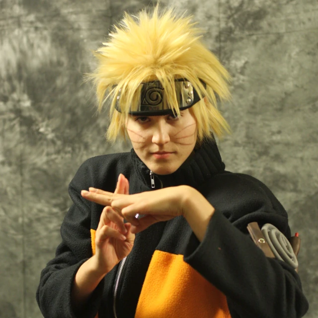 young man with blonde hair dressed in a costume pointing