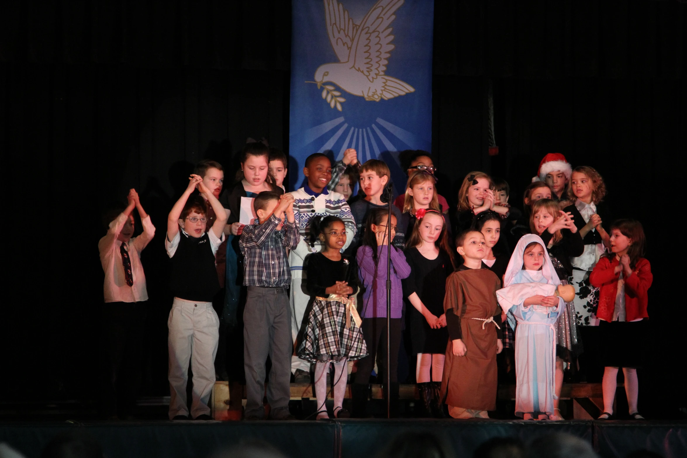 a group of s with a star above them in front of a stage