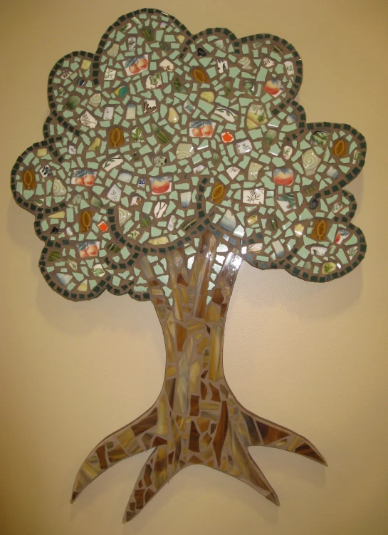 a mosaic tree made out of several small plates