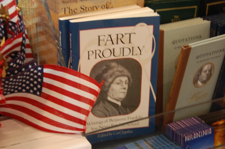 a book is lying next to an american flag