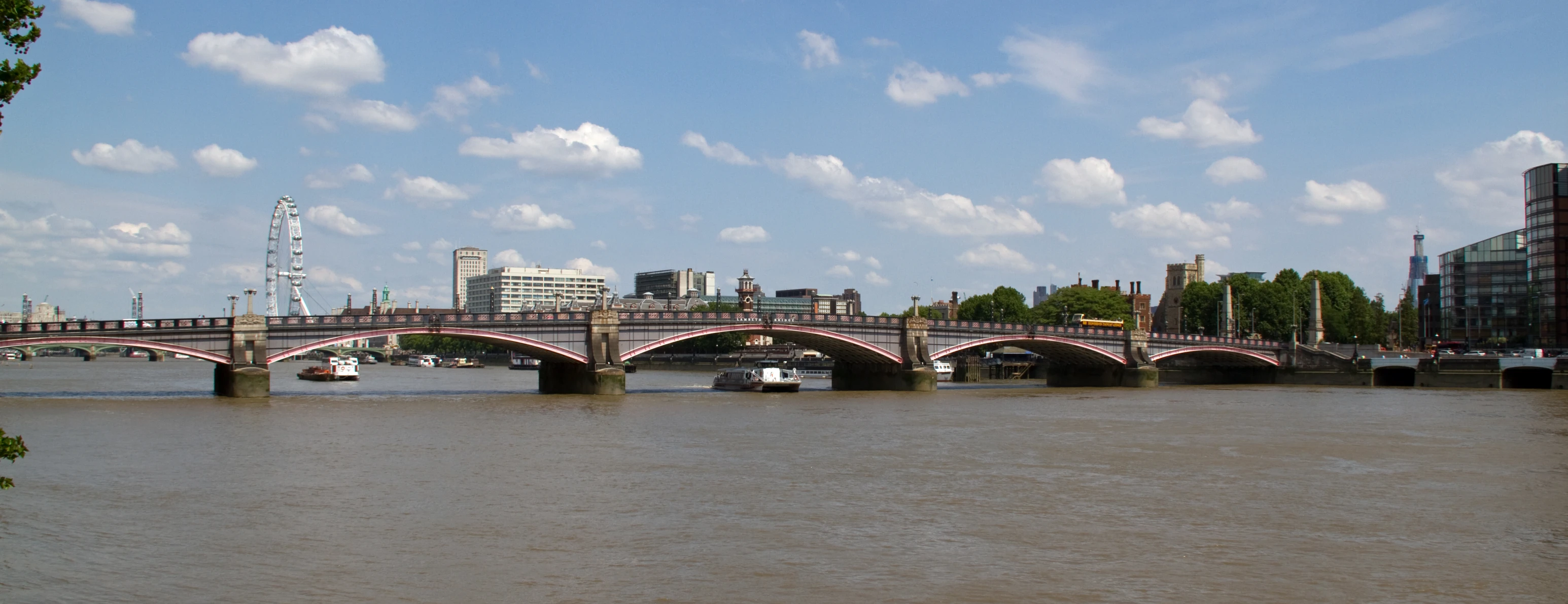 a bridge is above the brown water