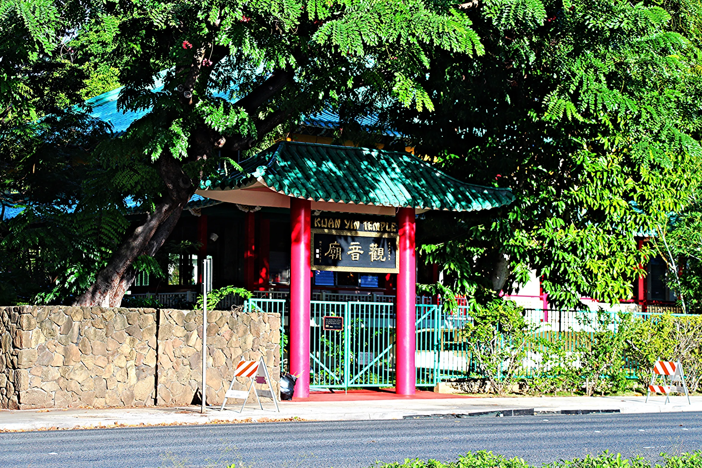 a street sign is shown with a small gazebo