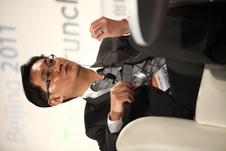 a man in a suit sitting on top of a chair