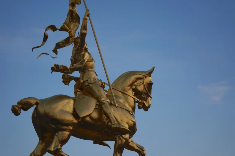 a statue of a man on horseback is surrounded by birds