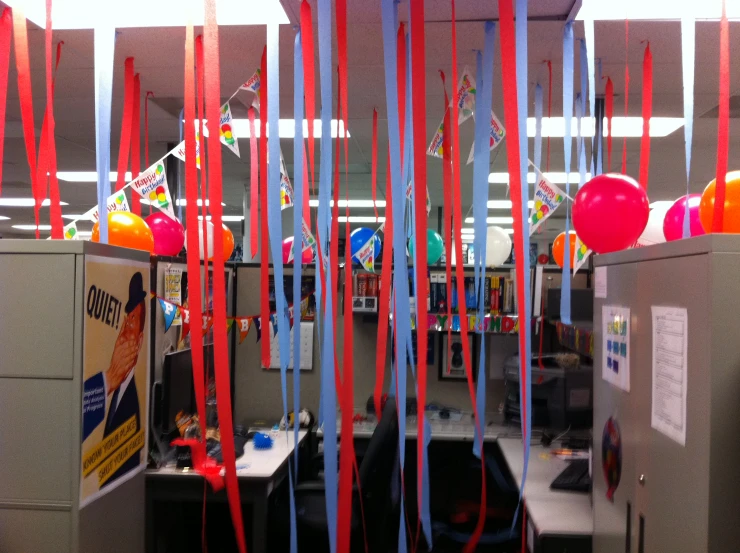 a cubicle with several red, white and blue streamers