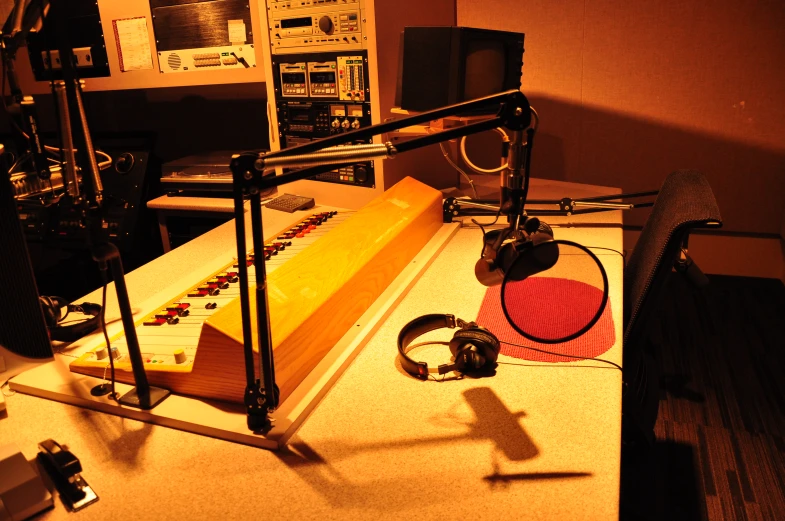 a recording studio with headphones, microphone, sound board and speakers