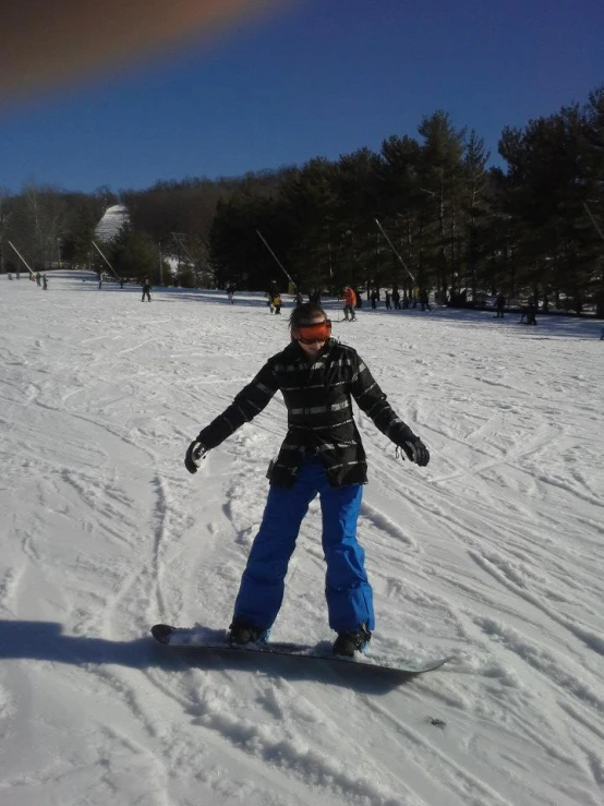 a person in the snow with one foot on his snowboard