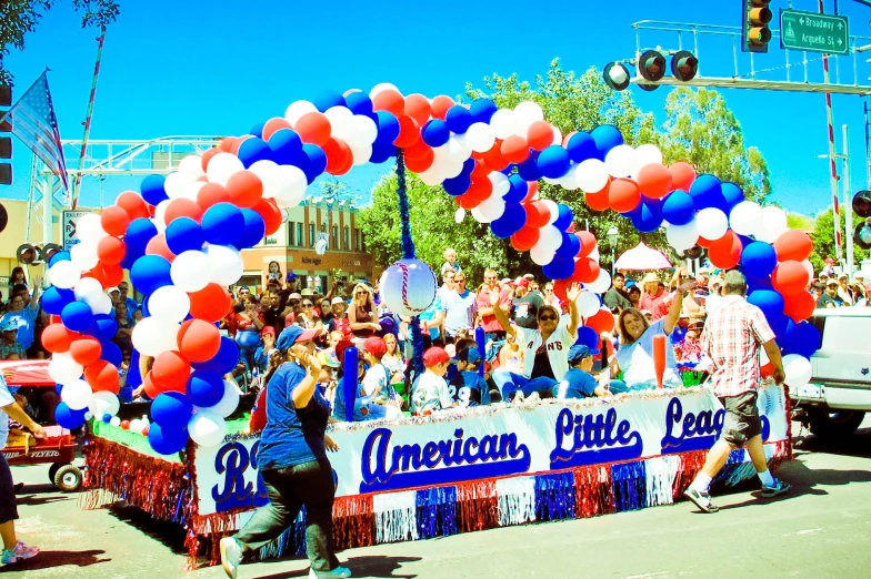 a parade float featuring american's blue, white and red balloons