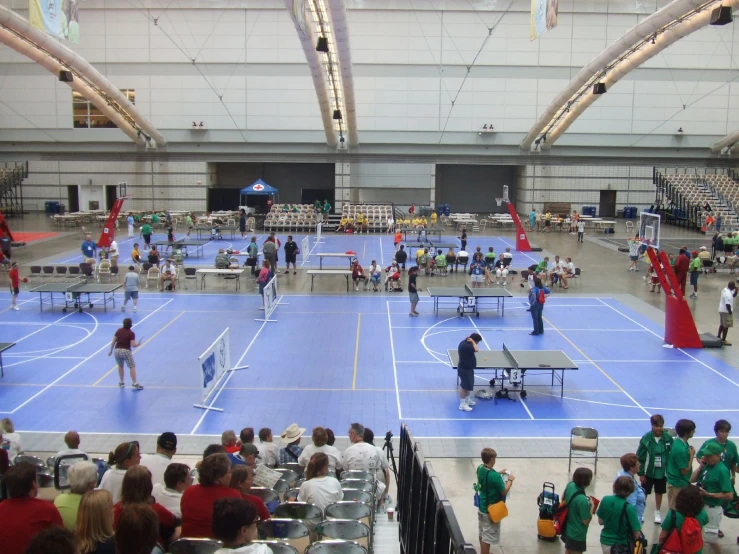 an indoor tennis court with lots of tables and chairs