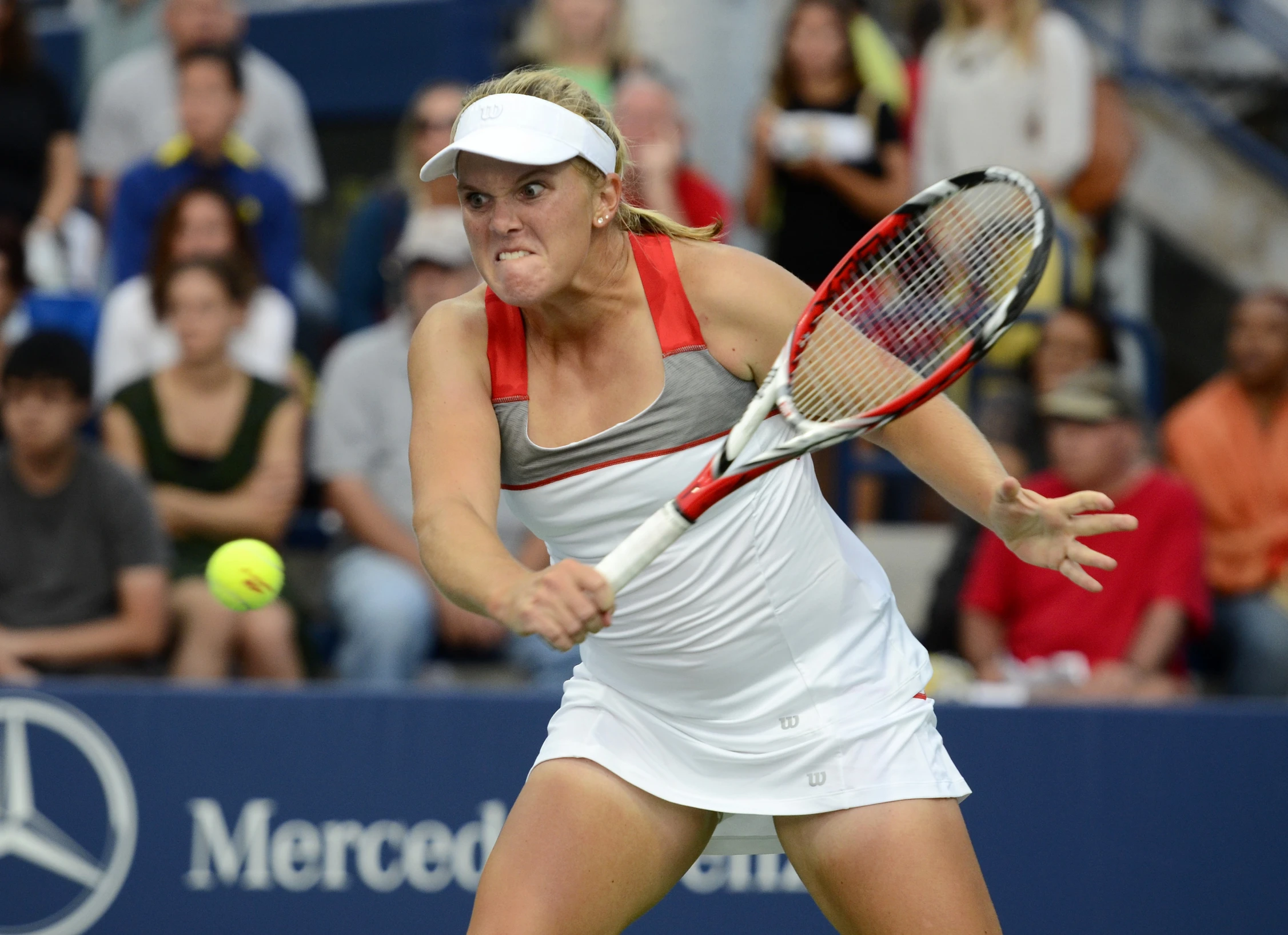 the tennis player is playing tennis in front of fans