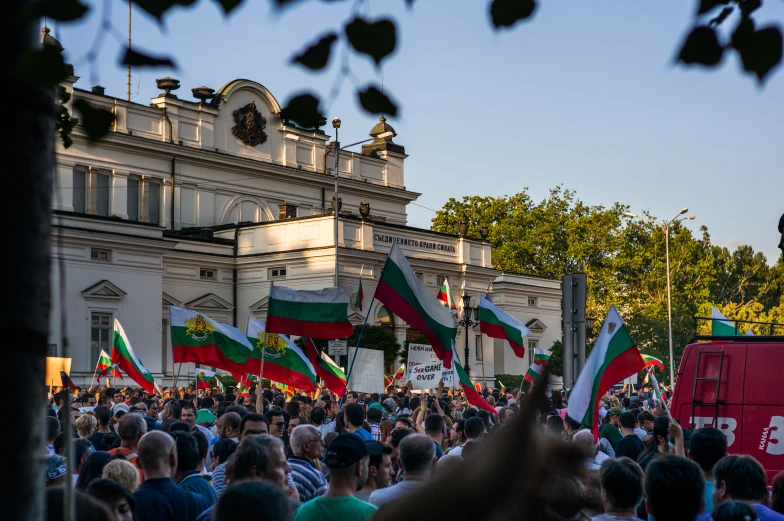 a large group of people are protesting on a city street