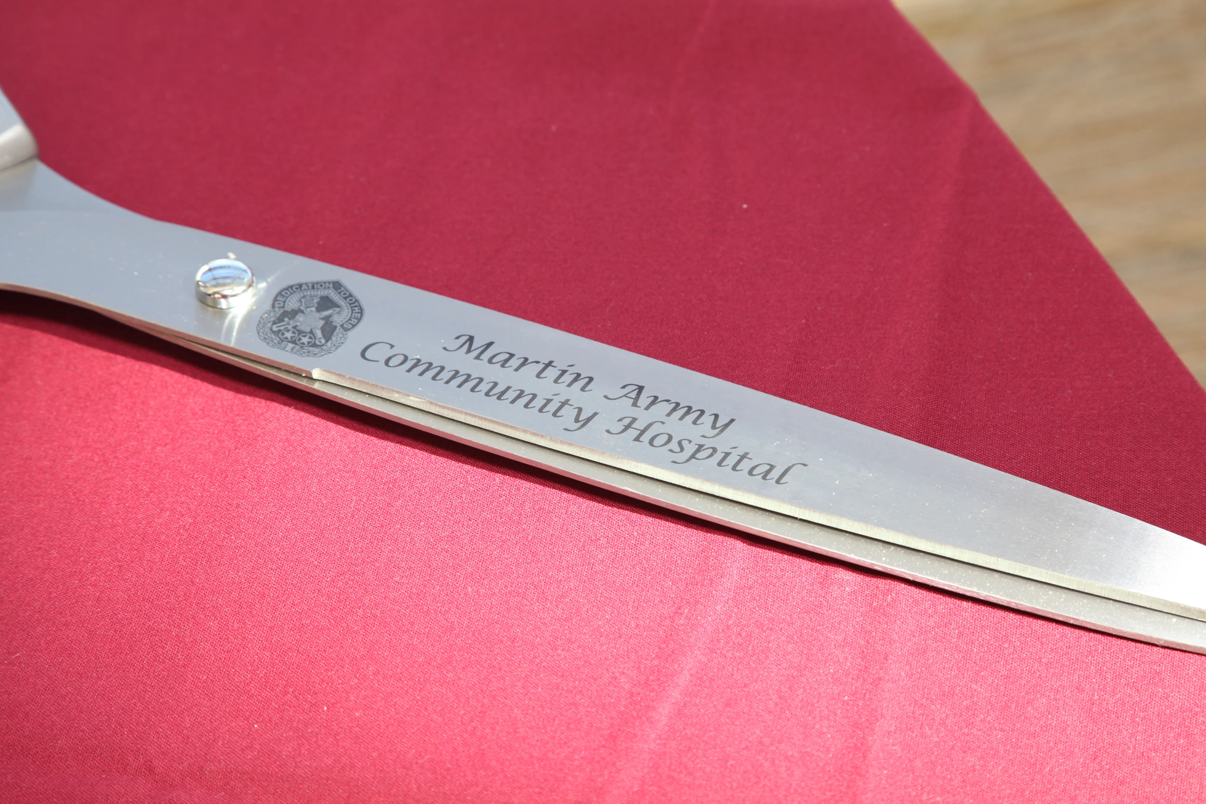 a close up view of a small long knife on a red table