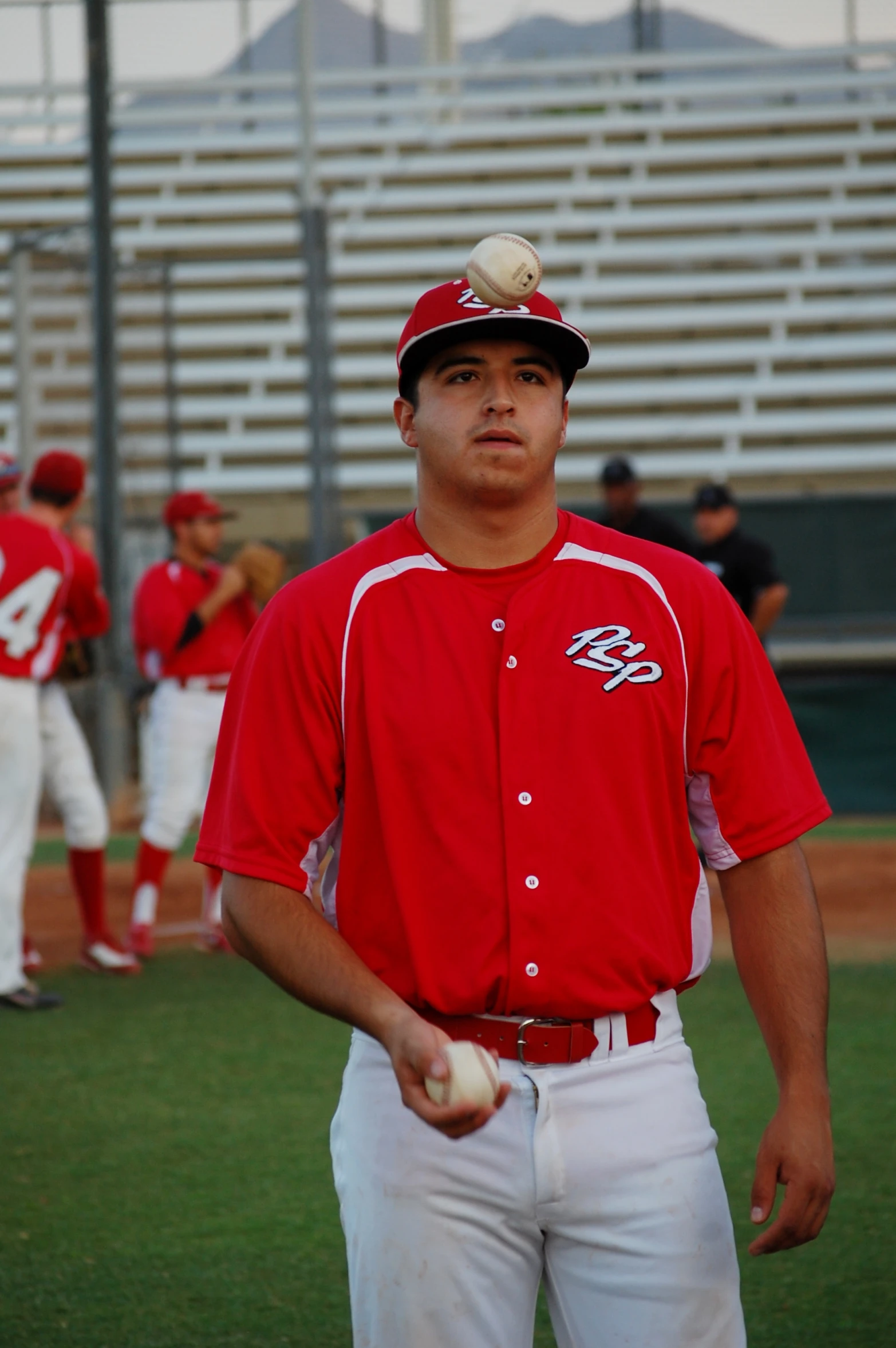 baseball players are standing on the field with hats on