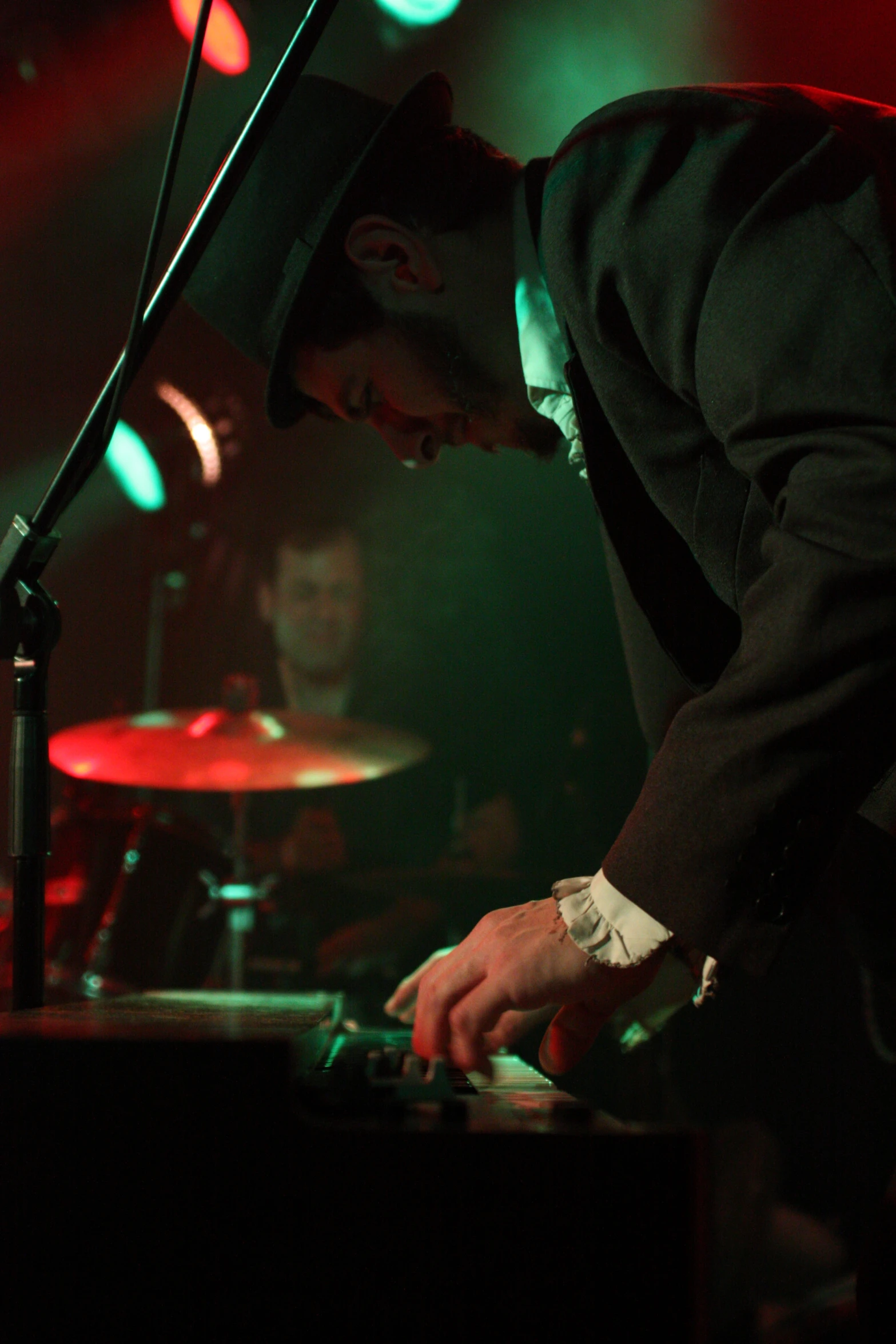 a person in black jacket standing at a keyboard