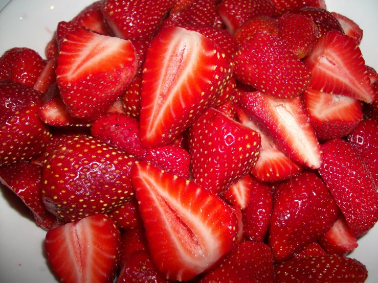 there are many strawberries scattered on a plate