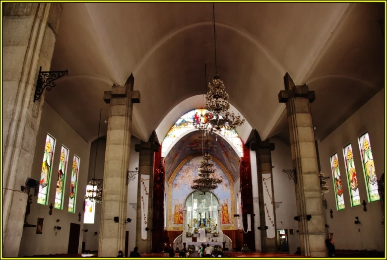 interior of a church with two massive vaulted ceilings and large chandeliers