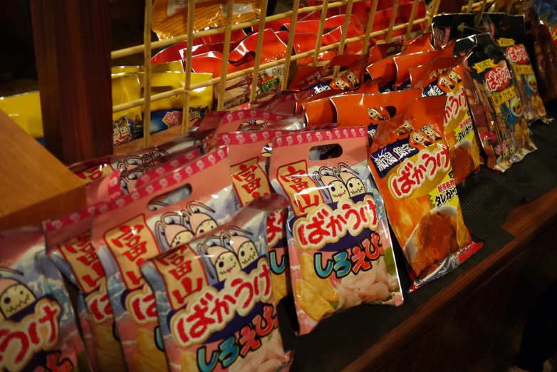 many packets of candy in a shop display