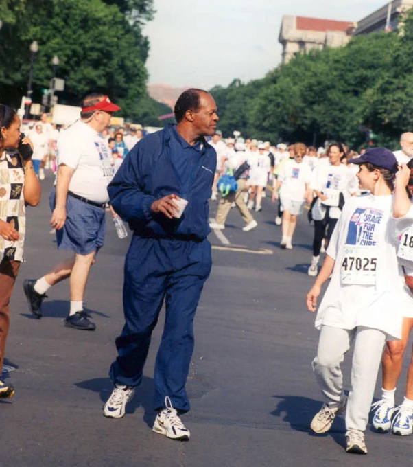 a man walking next to a young child wearing a shirt