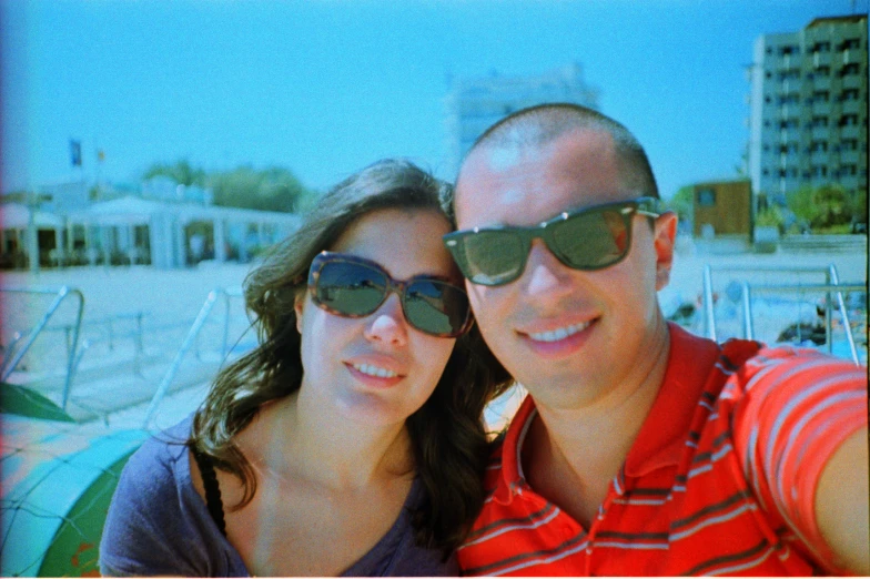 man and woman standing next to each other taking selfie