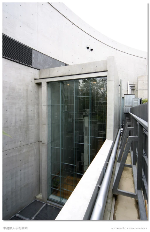 an outside balcony with sliding doors and concrete wall