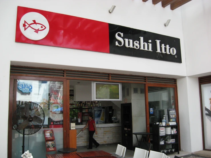 asian style restaurant in urban area with large sign over door