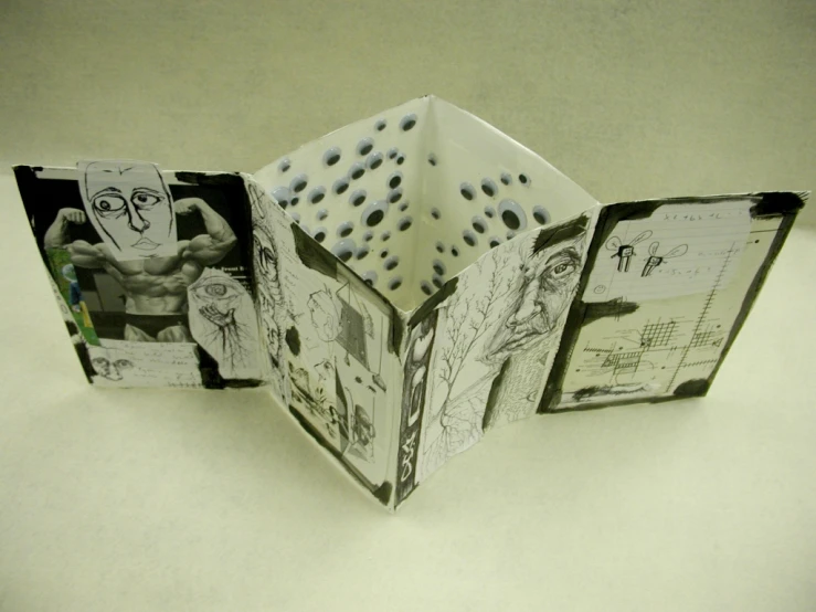 an open book with pictures inside it on the table