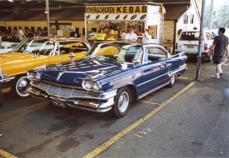 several old fashion cars are parked outside an eatery