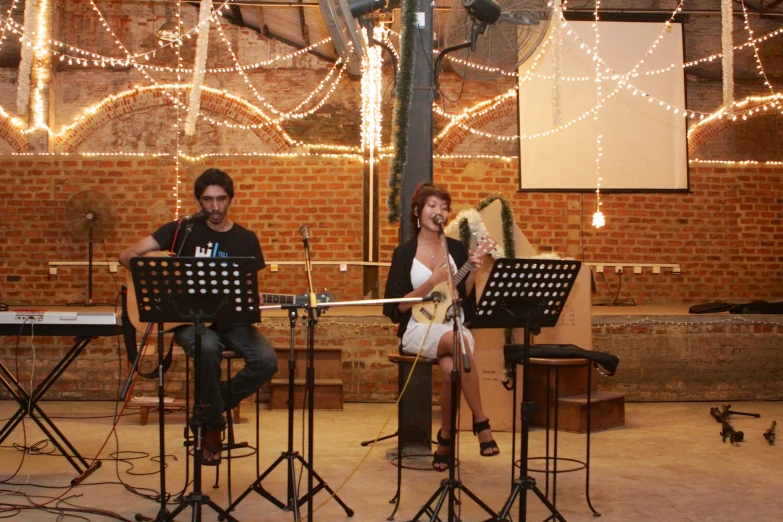 people sitting at a bar playing instruments on stage