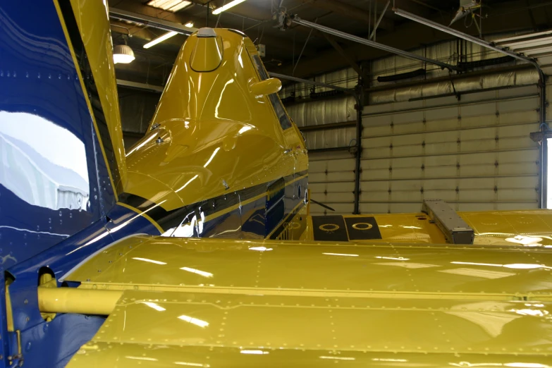 some airplane parts and other things are parked inside of a building