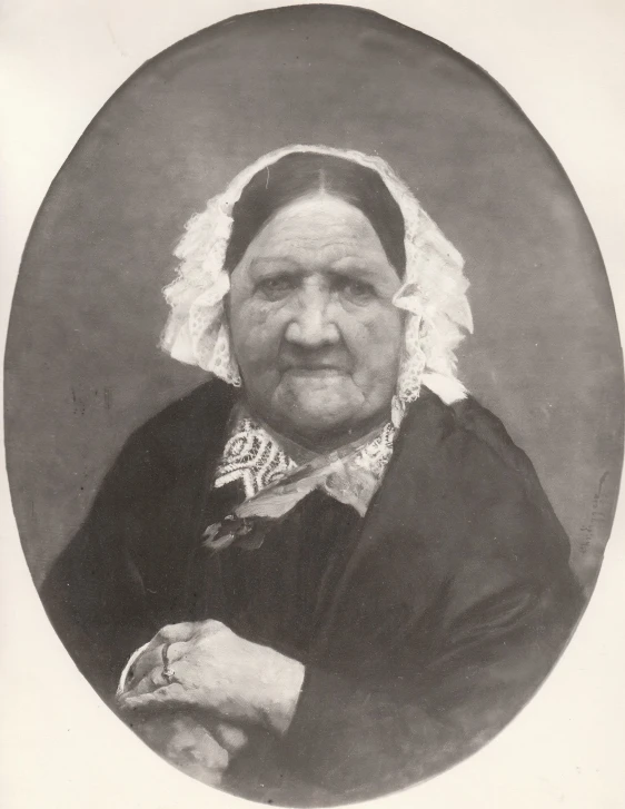 an old black and white pograph of a woman in an old fashion dress