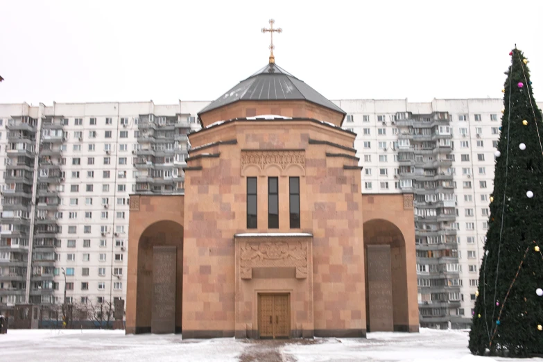 a church in a city with christmas trees