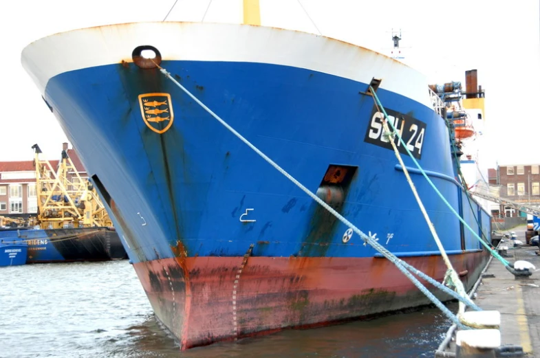 the large boat is docked at the pier