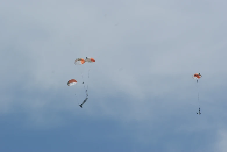 several different types of parachutes in the sky