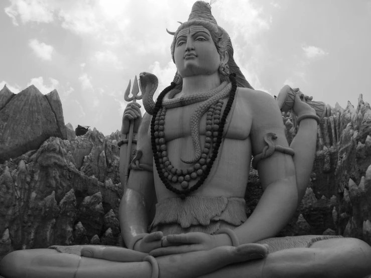 a statue with several items around it in black and white