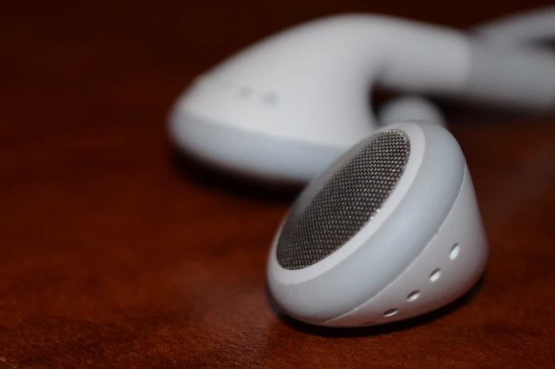 two white speakerphones sitting side by side on top of a table