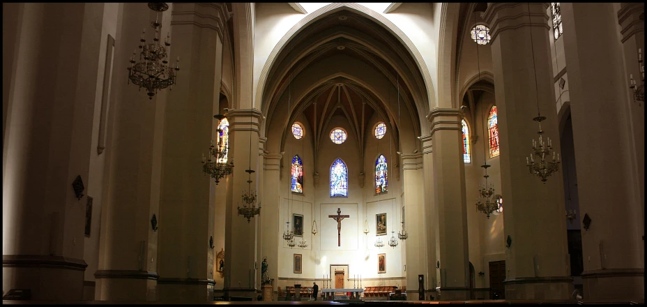 view of cathedral with columns, stained glass windows and pew