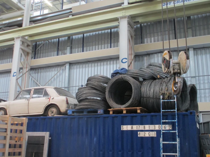 several large metal pipes sitting on top of a blue container