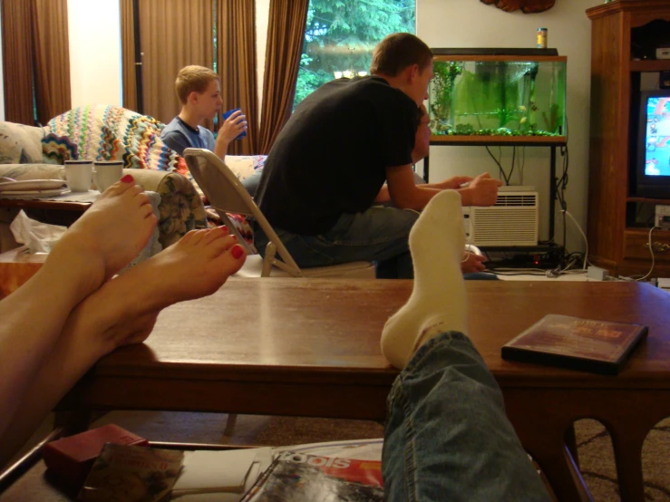 a group of people sitting at a table in front of a tv