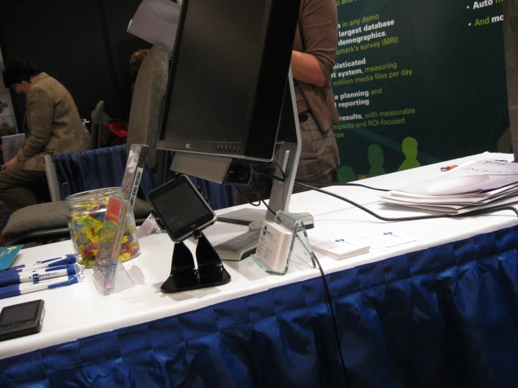 a table with a laptop, tablet, and tv on it