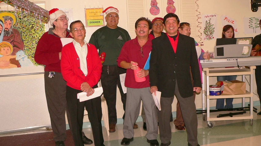 people dressed in elf outfits pose together in a classroom