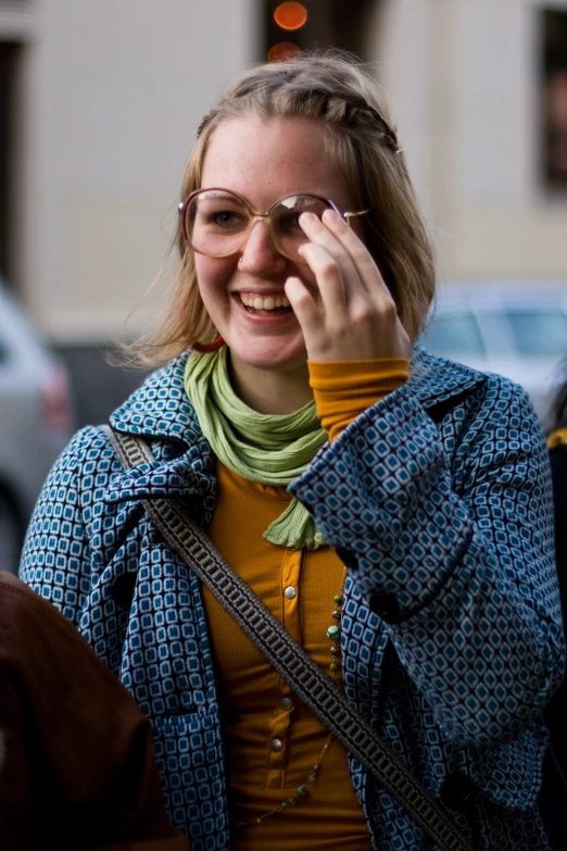 a woman is talking on a cell phone while holding a glass