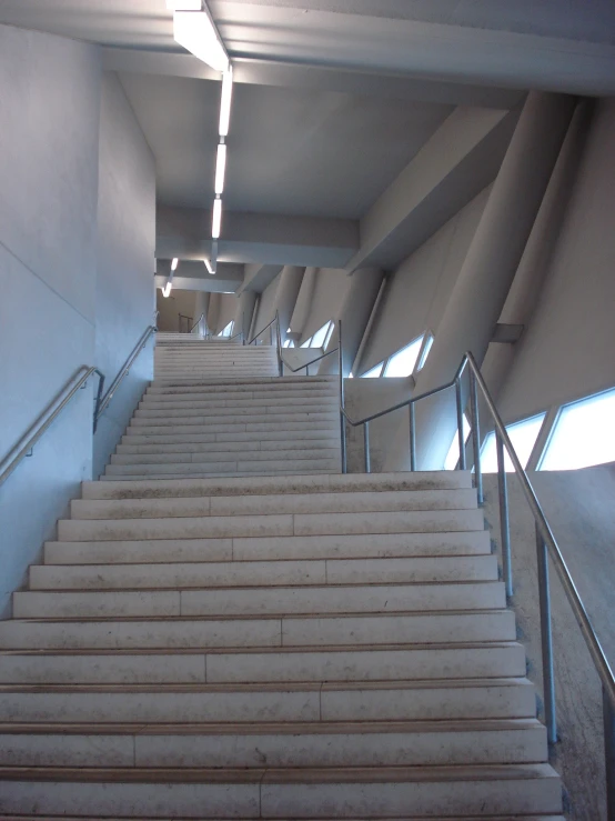 a group of stairs with hand rails going down