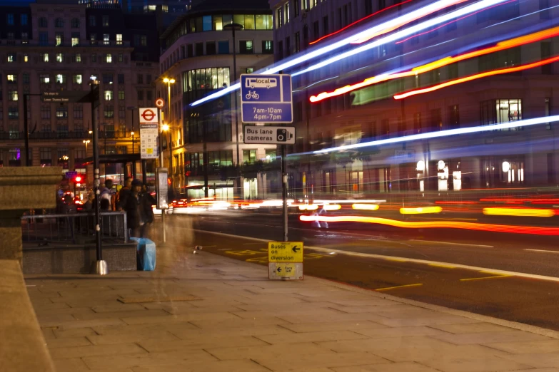 a street filled with traffic next to tall buildings