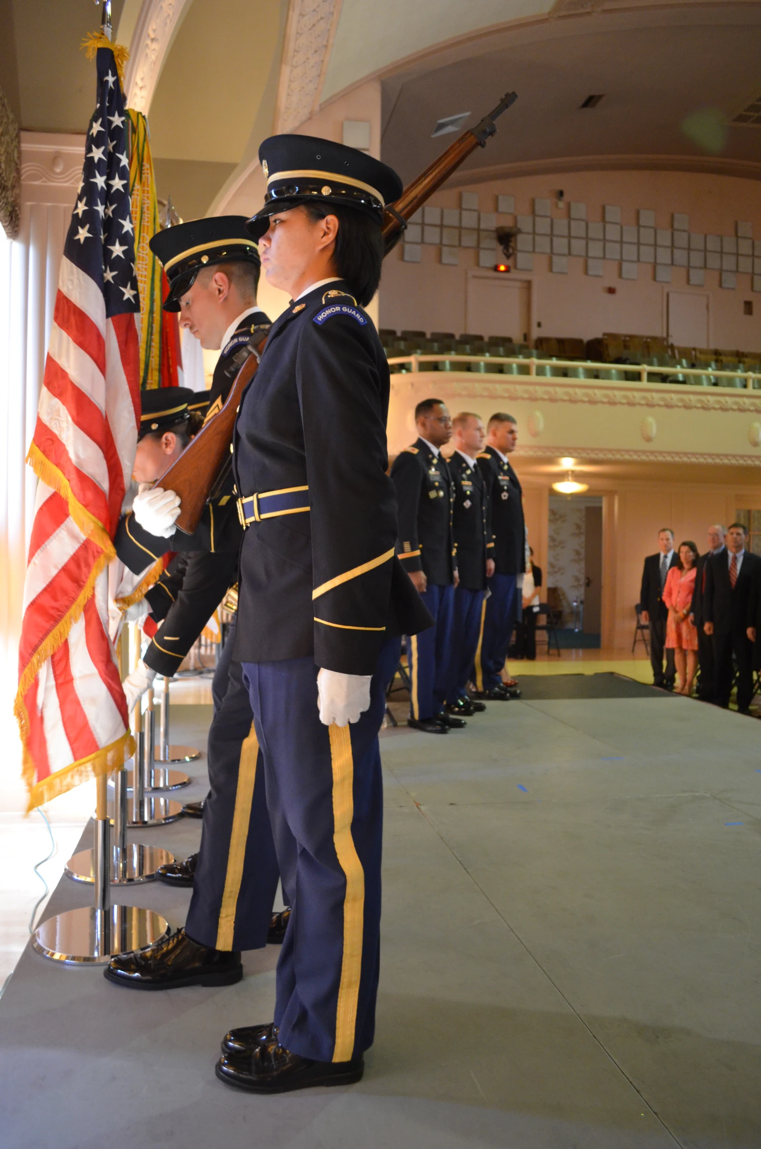 military ceremony with men in uniform holding flags and medals