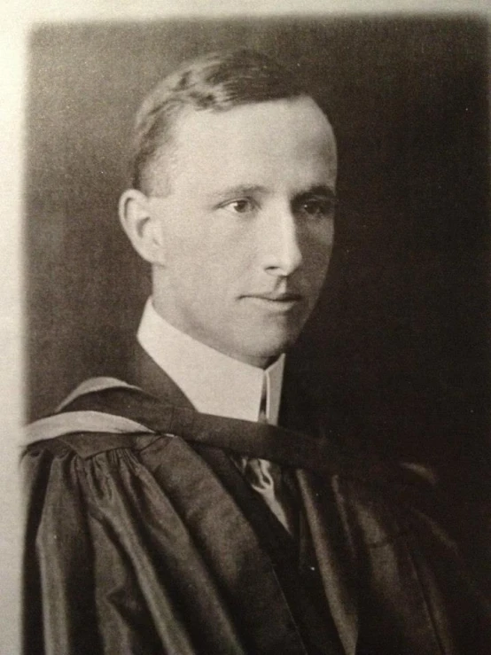 this is a black and white po of a man in his graduation robes