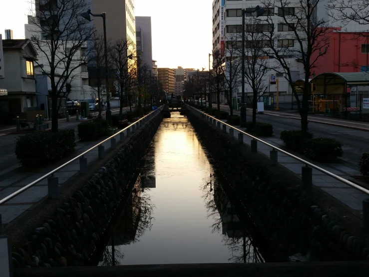 a small water channel between buildings in a city