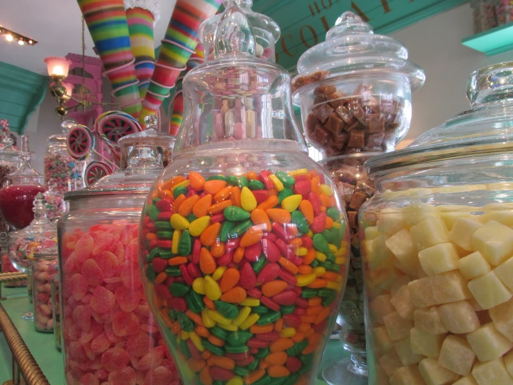 the candy is in different jars and flavors