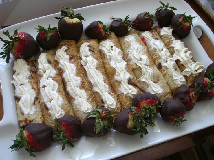 a white platter topped with a serving dish of desserts