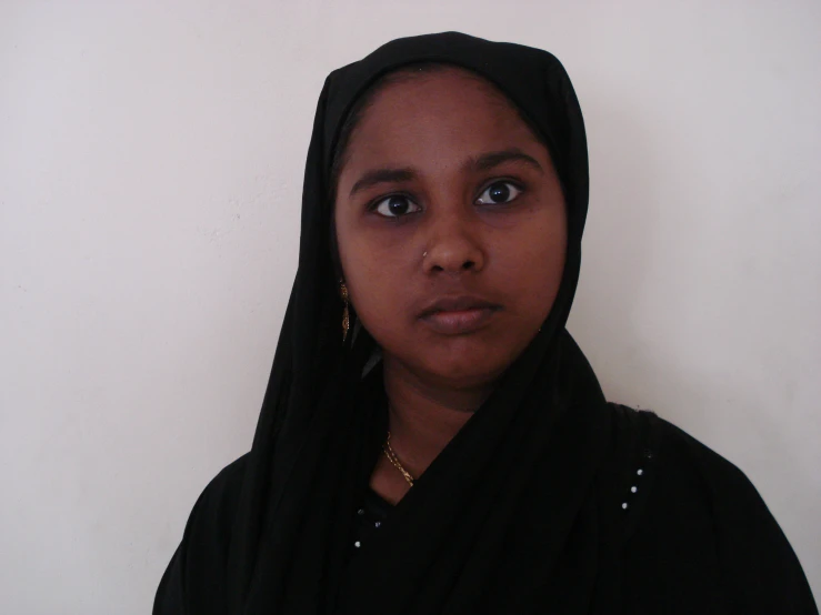 a person with a black shawl on posing